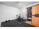 Home gym with exercise equipment, rubber flooring, and a personal sauna for relaxation and fitness at 4956 Waterside Cir, Carmel, IN 46033