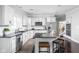 Modern kitchen with white cabinets, dark countertops, and stainless steel appliances at 4956 Waterside Cir, Carmel, IN 46033