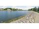 Scenic lakeside view with clear water and rock lined shore of a community lake with surrounding homes at 4956 Waterside Cir, Carmel, IN 46033