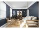 Stylish living room with unique seating, dark accent wall, and natural light at 4956 Waterside Cir, Carmel, IN 46033