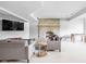 Spacious living room featuring a cozy fireplace, comfortable seating, and a wall-mounted TV for entertainment at 4956 Waterside Cir, Carmel, IN 46033