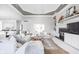 A spacious living room with a fireplace, built-in shelving, and plenty of natural light at 4956 Waterside Cir, Carmel, IN 46033