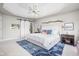 Bright main bedroom with a tray ceiling, barn doors, and natural light at 4956 Waterside Cir, Carmel, IN 46033