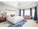 Bright main bedroom with a seating area, tray ceiling, and natural light at 4956 Waterside Cir, Carmel, IN 46033