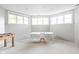 Bright office space with multiple windows, white table and chair, and a foosball table for recreation at 4956 Waterside Cir, Carmel, IN 46033