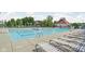 Community swimming pool featuring lounge chairs and a lifeguard stand under a sunny, partly cloudy sky at 4956 Waterside Cir, Carmel, IN 46033