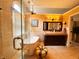 Bright bathroom with a glass shower, soaking tub, and dark wood vanity with double sinks at 5190 Pursel Ln, Carmel, IN 46033