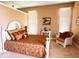 Well-lit bedroom featuring a comfortable bed, cozy sitting chair, and warm, inviting decor at 5190 Pursel Ln, Carmel, IN 46033