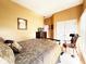 Cozy bedroom showcasing a comfortable bed, wardrobe and ample closet space at 5190 Pursel Ln, Carmel, IN 46033