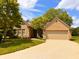 Charming brick home featuring a well-manicured lawn, beautiful trees, and a spacious two-car garage at 5190 Pursel Ln, Carmel, IN 46033
