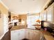 Open kitchen featuring a breakfast bar, granite countertops, white cabinets, and a cozy breakfast nook at 5190 Pursel Ln, Carmel, IN 46033