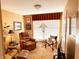 Inviting living room with a comfortable recliner, a large window with blind, and TV at 5190 Pursel Ln, Carmel, IN 46033