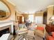 Inviting living room with a fireplace, comfortable armchairs, and an open view to the dining area at 5190 Pursel Ln, Carmel, IN 46033