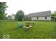 Expansive fenced backyard with lush green grass and comfortable seating arrangement at 533 Charnwood Pkwy, Beech Grove, IN 46107