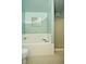 Bright bathroom with a tub, a glass-door shower, tiled floors and light green walls at 533 Charnwood Pkwy, Beech Grove, IN 46107