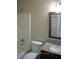 This bathroom features a shower-tub, toilet, and sink with granite countertop at 533 Charnwood Pkwy, Beech Grove, IN 46107