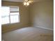 Neutral bedroom with wall-to-wall carpeting, a window with blinds, and neutral paint at 533 Charnwood Pkwy, Beech Grove, IN 46107