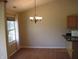Charming dining room with natural light, a modern chandelier, and hardwood floors at 533 Charnwood Pkwy, Beech Grove, IN 46107