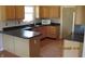 Efficient kitchen with wood cabinets, dark countertops, a microwave and hardwood floors at 533 Charnwood Pkwy, Beech Grove, IN 46107