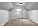 Attic bedroom with neutral carpet, window and sloping ceiling at 5840 Brouse Ave, Indianapolis, IN 46220