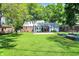 Expansive backyard with a well-manicured lawn, deck, and garden beds, offering plenty of space for recreation at 5840 Brouse Ave, Indianapolis, IN 46220