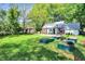 Spacious backyard featuring a deck, brick-lined garden beds, and a well-maintained lawn, ideal for outdoor activities at 5840 Brouse Ave, Indianapolis, IN 46220