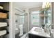 Well-lit bathroom featuring a glass-enclosed shower with a tiled surround and vanity with storage at 5840 Brouse Ave, Indianapolis, IN 46220