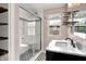 Updated bathroom with glass-enclosed shower, decorative tile, and marble vanity at 5840 Brouse Ave, Indianapolis, IN 46220