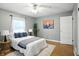 Inviting bedroom featuring hardwood floors, plush rug, and soft natural light, perfect for relaxation at 5840 Brouse Ave, Indianapolis, IN 46220