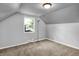 Slanted ceiling bedroom with neutral tones and natural light at 5840 Brouse Ave, Indianapolis, IN 46220