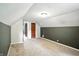 Neutral carpeted bedroom with combination of grey and white paint, with a hallway door for convenient access at 5840 Brouse Ave, Indianapolis, IN 46220