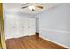 A bedroom with hardwood floors and a large closet with multiple doors at 5840 Brouse Ave, Indianapolis, IN 46220