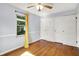 Bright bedroom with hardwood floors, built-in wardrobe and drawers, and a window at 5840 Brouse Ave, Indianapolis, IN 46220