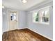 A bedroom with hardwood floors, windows, and a door leading outside at 5840 Brouse Ave, Indianapolis, IN 46220