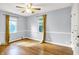 A bedroom with hardwood floors, a ceiling fan, and two windows at 5840 Brouse Ave, Indianapolis, IN 46220