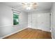 Comfortable bedroom with hardwood floors, built-in cabinets and large window for bright natural light at 5840 Brouse Ave, Indianapolis, IN 46220