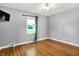 Bedroom with hardwood floors and one window with curtains at 5840 Brouse Ave, Indianapolis, IN 46220