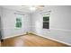 Bright bedroom featuring hardwood floors and large windows, offering plenty of natural light and ventilation at 5840 Brouse Ave, Indianapolis, IN 46220