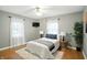 Cozy bedroom with hardwood floors, ceiling fan, and bright windows for ample natural light at 5840 Brouse Ave, Indianapolis, IN 46220