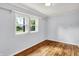 A bright bedroom with hardwood floors and two windows for natural light at 5840 Brouse Ave, Indianapolis, IN 46220