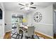 Charming dining room featuring a ceiling fan, stylish decor, and a view into the living room at 5840 Brouse Ave, Indianapolis, IN 46220
