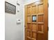 Close up of a decorative front door with hardware, wall decor and electronic control panel at 5840 Brouse Ave, Indianapolis, IN 46220