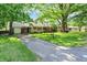 Quaint brick home with attached garage, set back on a deep grassy lot at 5840 Brouse Ave, Indianapolis, IN 46220