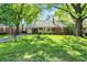 Lovely brick home with a spacious front yard and mature shade trees at 5840 Brouse Ave, Indianapolis, IN 46220