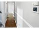 Hallway features hardwood floors, fresh paint, and classic trim at 5840 Brouse Ave, Indianapolis, IN 46220