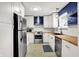Modern kitchen featuring white cabinets, stainless steel appliances and wooden counters at 5840 Brouse Ave, Indianapolis, IN 46220