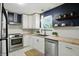 Modern kitchen featuring stainless steel appliances, light countertops, and white cabinets at 5840 Brouse Ave, Indianapolis, IN 46220