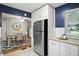 Stainless steel refrigerator next to the modern kitchen leading to a well appointed dining area at 5840 Brouse Ave, Indianapolis, IN 46220