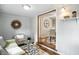 Charming living area opens to dining space, featuring a stylish accent wall and shelves at 5840 Brouse Ave, Indianapolis, IN 46220