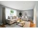 Sunlit living room with plush seating, a stylish rug, and a view of the outdoors at 5840 Brouse Ave, Indianapolis, IN 46220
